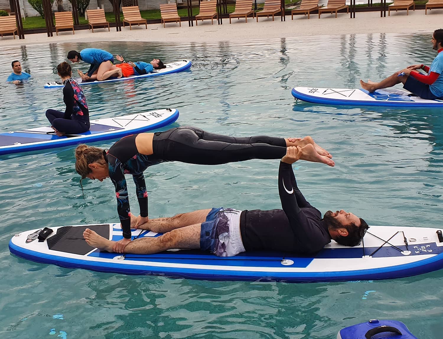 A couple practicing an acroyoga stance on an SPS Sport board