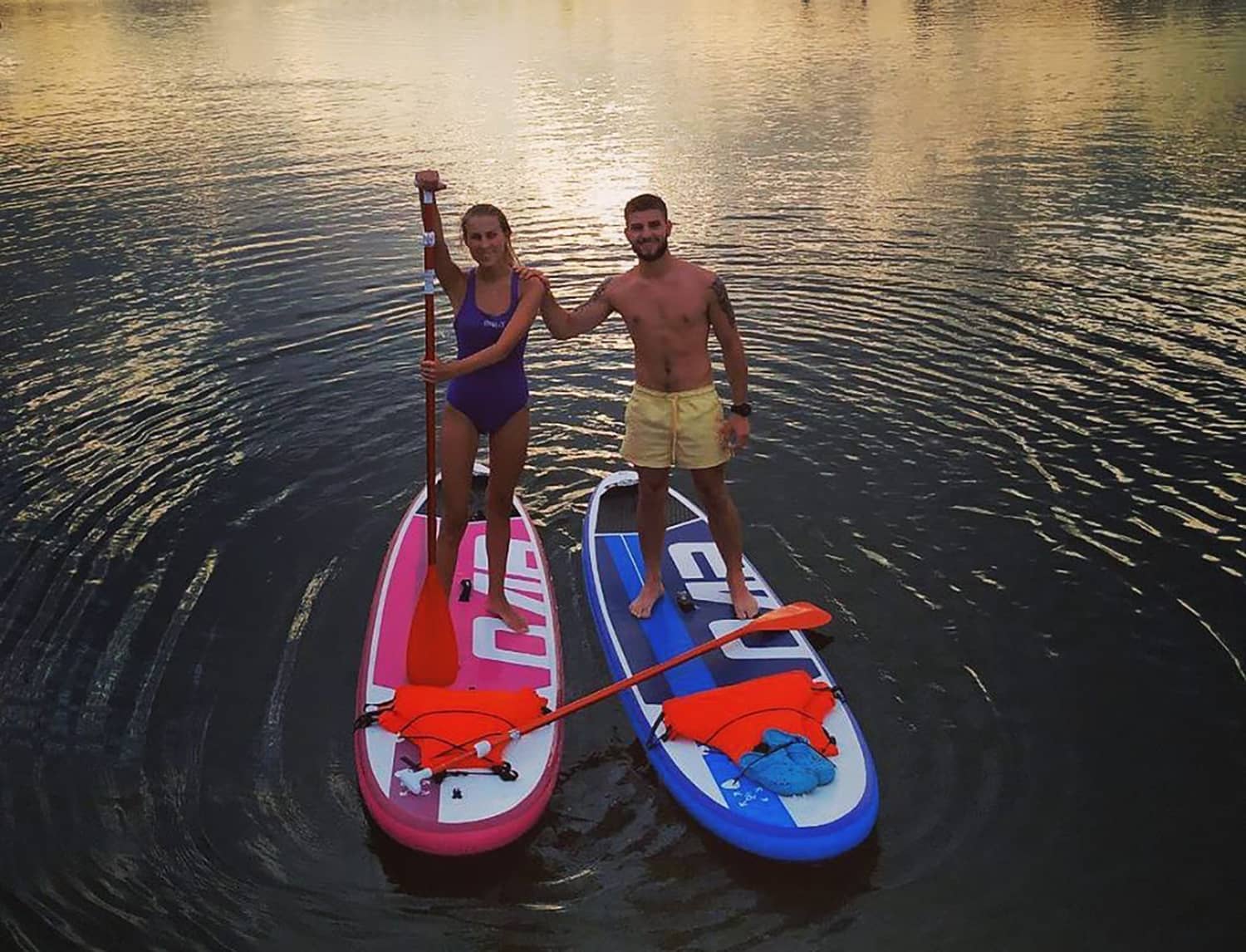Girl standing in a Pink Evo Sup and a boy standing next to her in a Blue Sup Evo